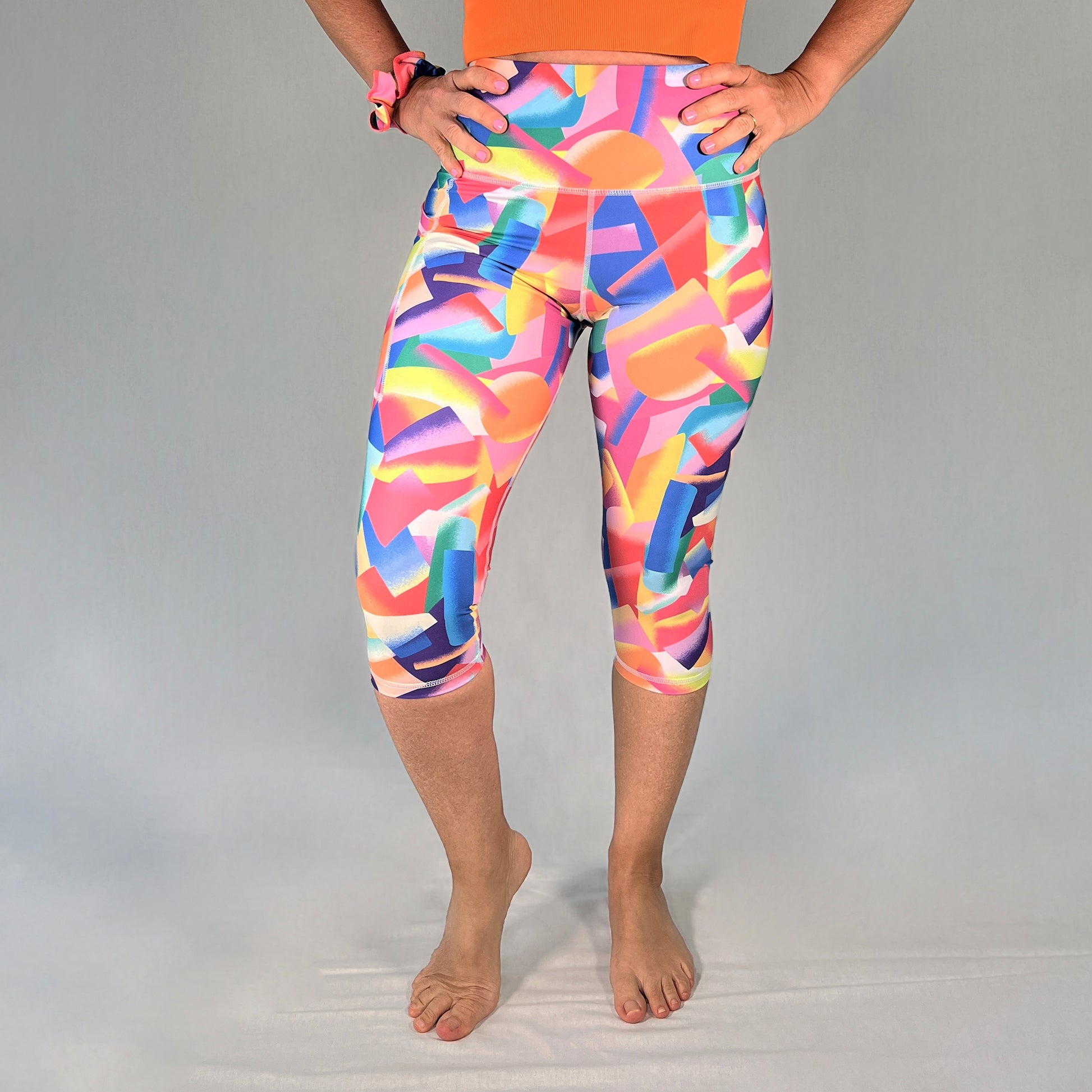 Front view of colourful 3/4-length leggings with pocket in Festive design by Art2Go Monique Baques