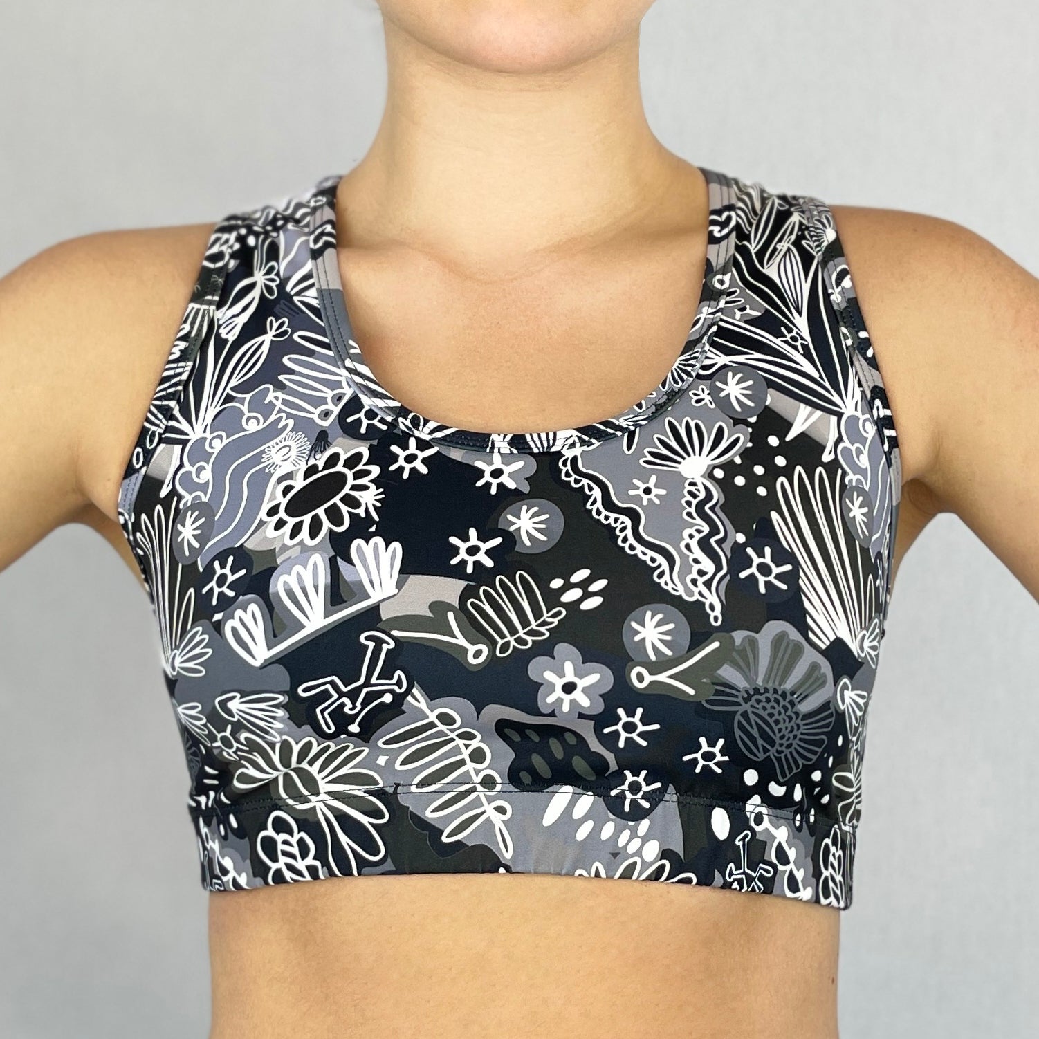 colourful sports bra made sustainably from recycled materials - black and white coral front