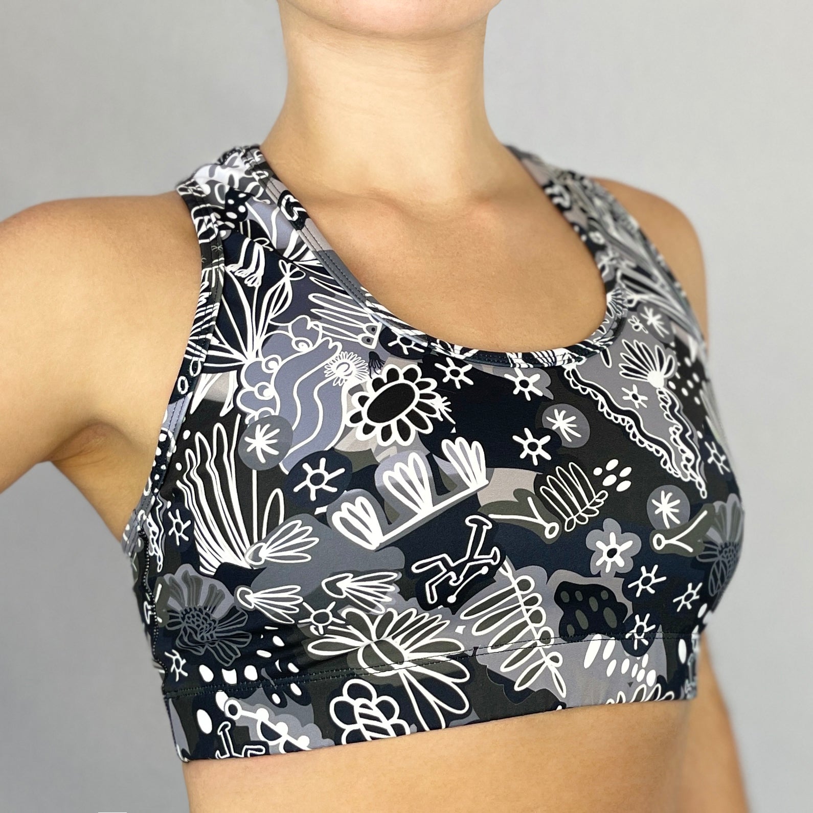 colourful sports bra made sustainably from recycled materials - black and white coral side