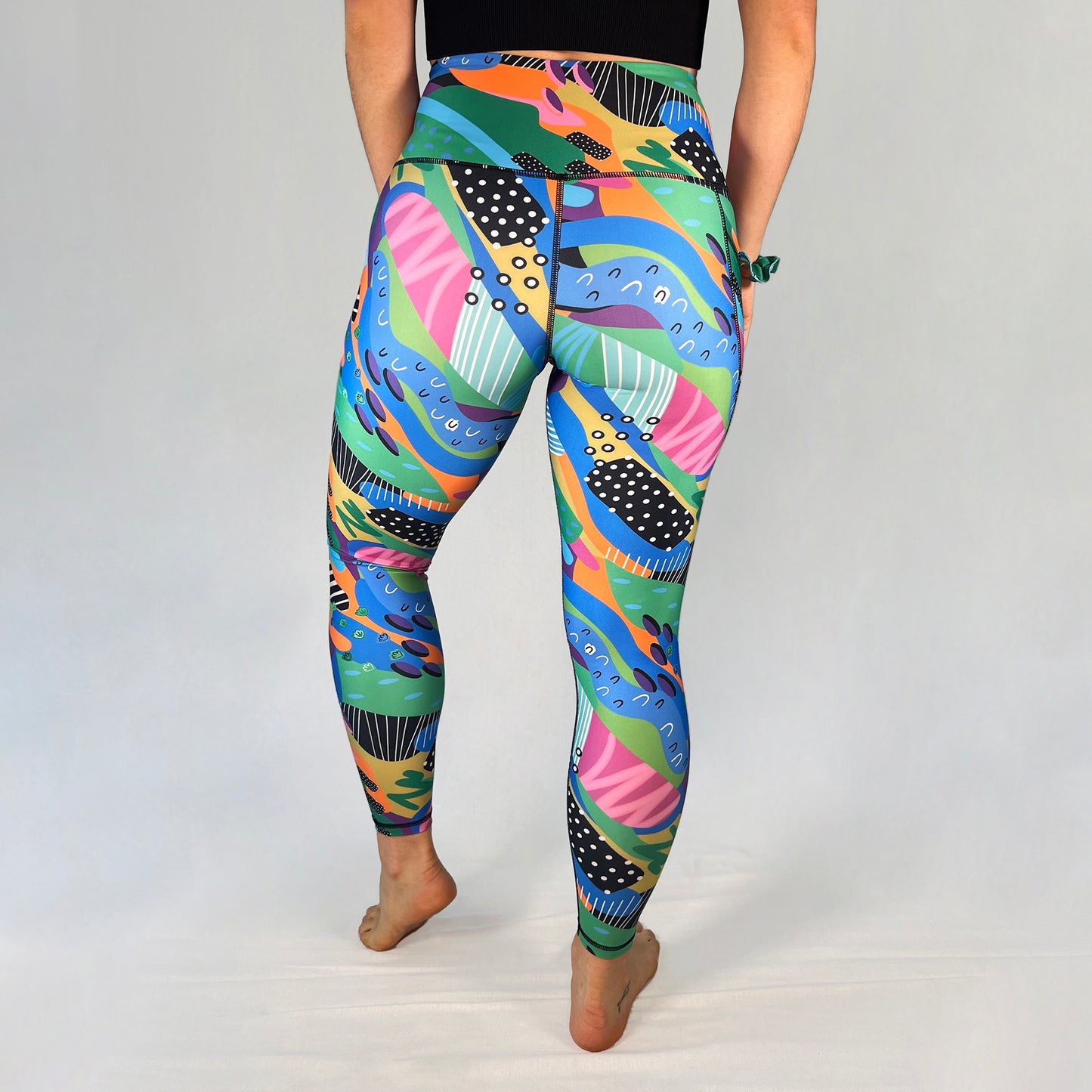 Back view of full-length leggings with pocket in Spark design by Art2Go Monique Baques