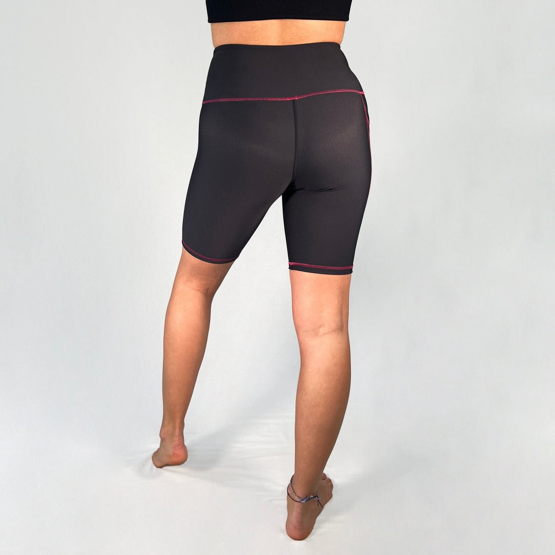 Back view of bike shorts with pocket in Black with pink stitching design by Art2Go Monique Baques