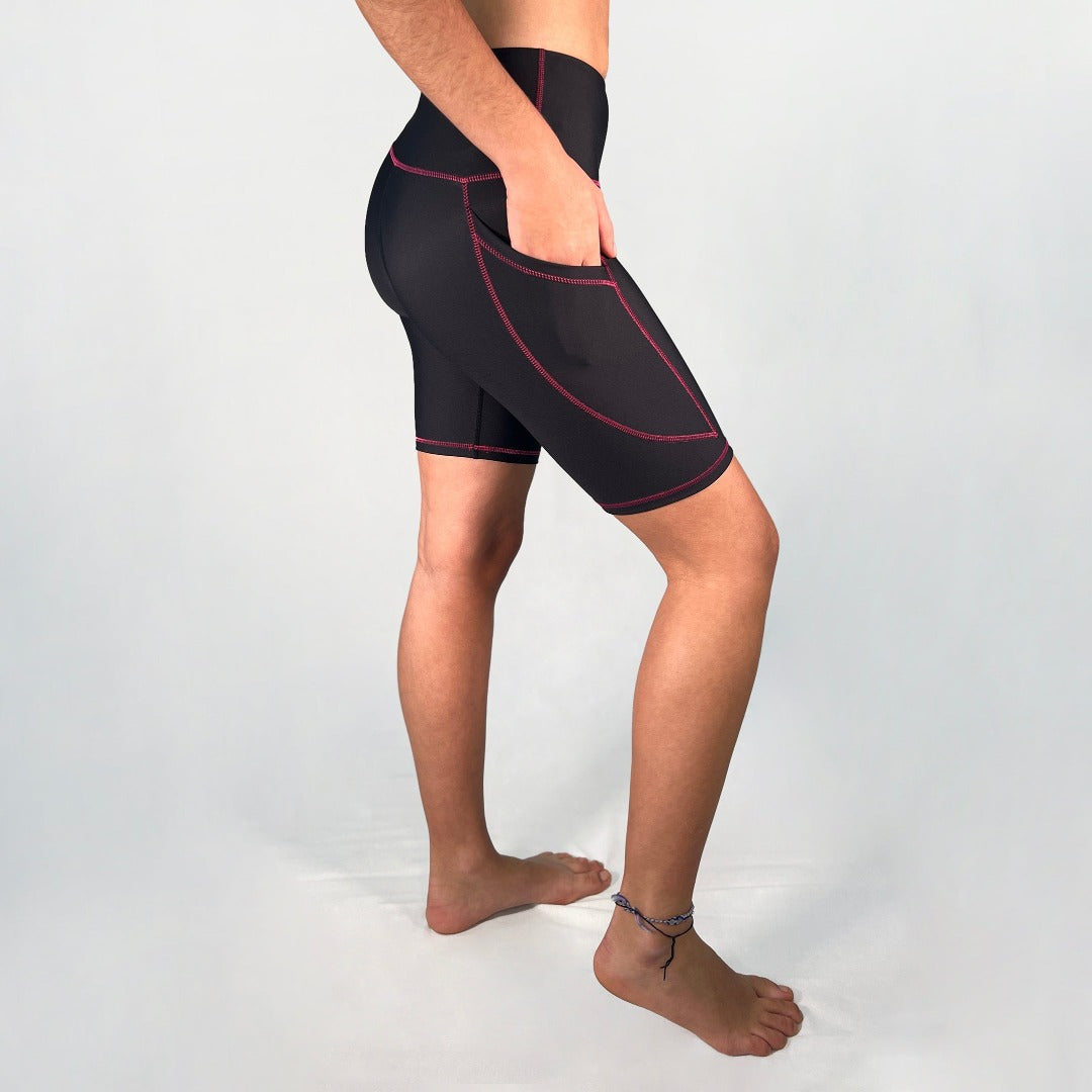Side view of bike shorts with pocket in Black with pink stitching design by Art2Go Monique Baques